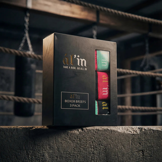 Box of 'al'in' boxer briefs with a boxing ring in the background